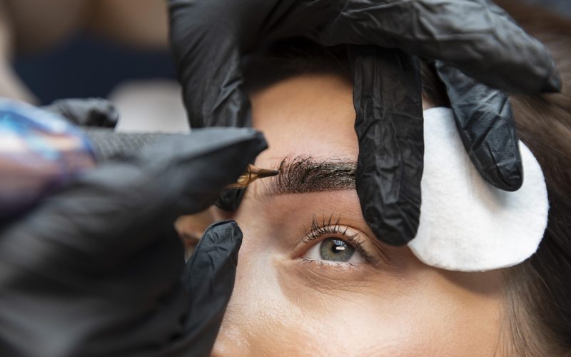 young-woman-getting-beauty-treatment-her-eyebrows